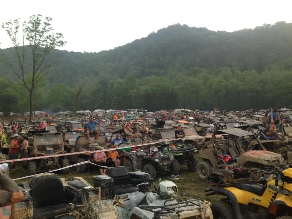 muddy ATVs parked